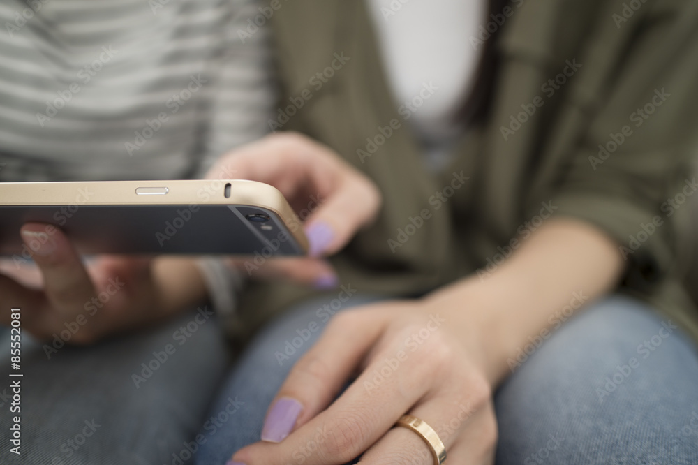 Women looking at smartphone together