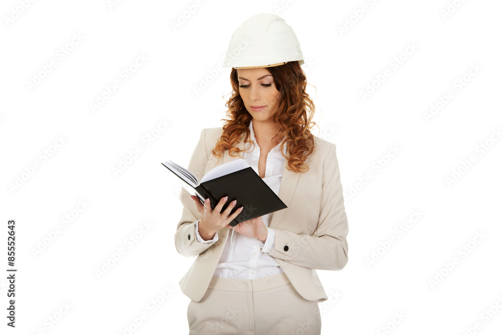 Engineer woman reading a note. Engineer woman reading a note.