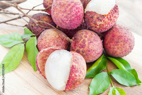 Closeup of lychee fruits on wooden board, fruits of asian