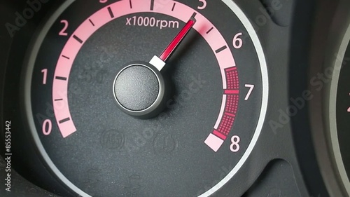 Car tachometer and moving pointer on it. photo