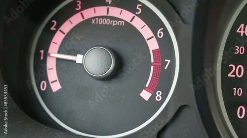 Car tachometer and moving pointer on it. photo