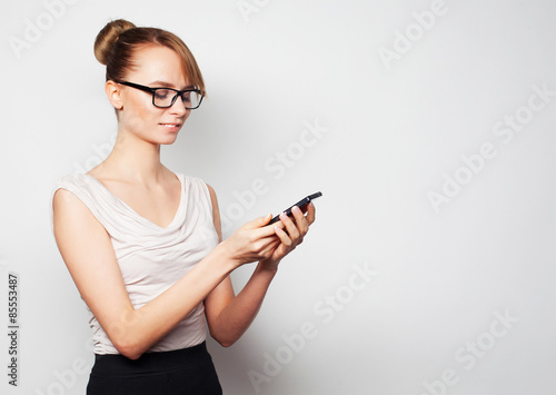 young businesswoman holding mobile phone