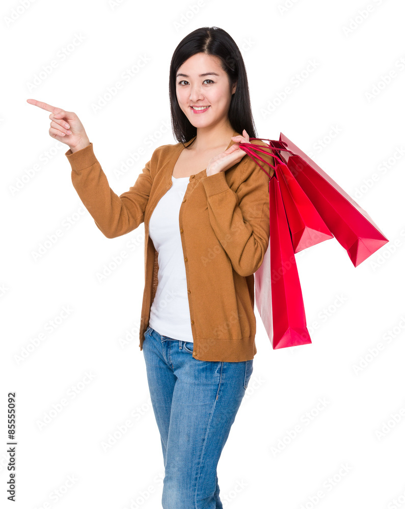 Asian young woman hold with shopping bag and finger point up Asian young woman hold with shopping bag and finger point up