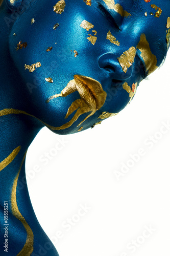 Halloween Makeup. Closeup beauty fashion Woman with blue gold Sk