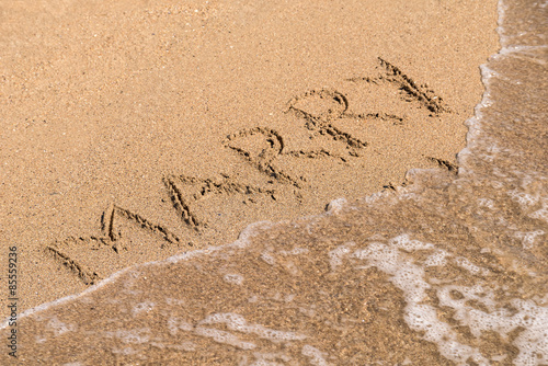 Marry Me Word Written On Sunny Summer Beach Sand