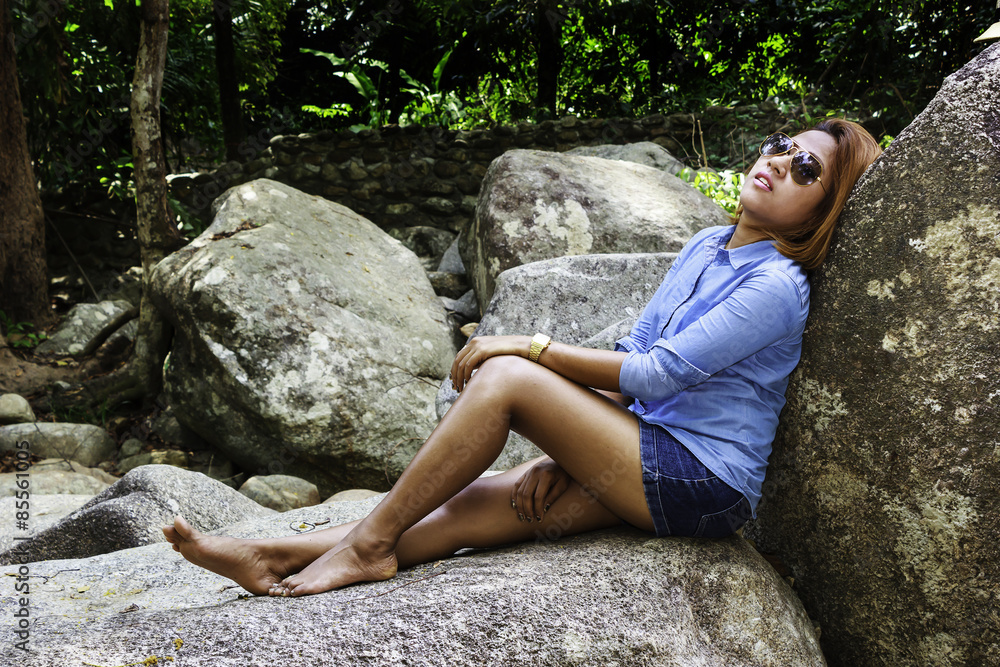 Asian woman relax on the rock
