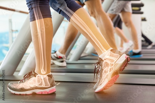 Highlighted ankle of woman on treadmill photo