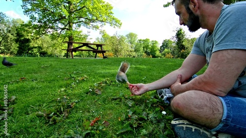 Man feeding squirrel in the park