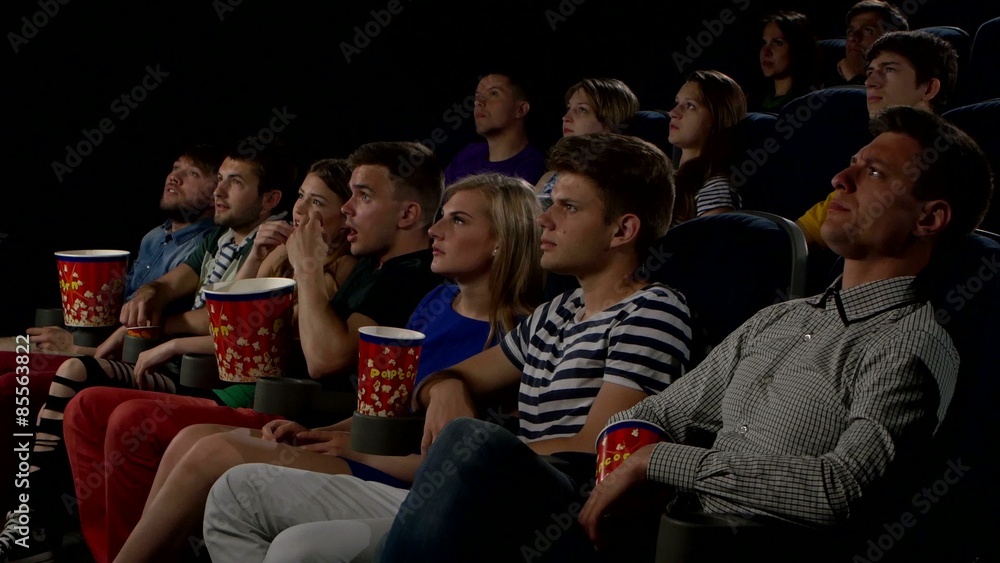 Young people watch movies in cinema: horror Young people watch movies in cinema: horror