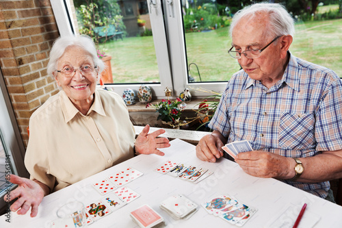 Elderly couple playing cards