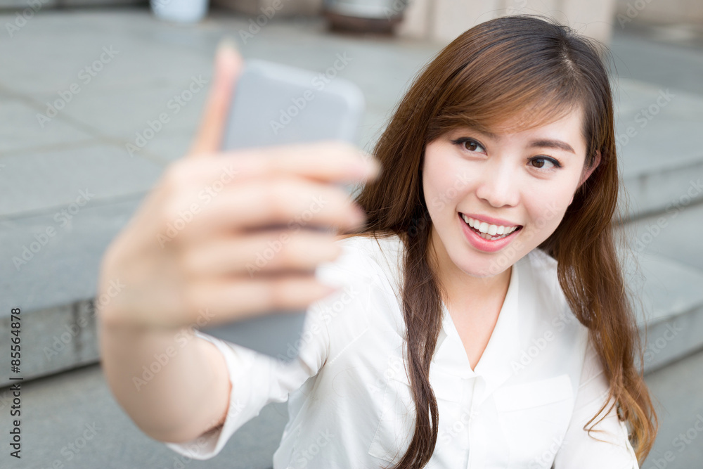 © zhu difeng - asian beautiful young woman using mobile phone to take selfie ou