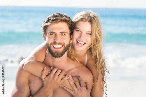 Happy couple relaxing together in the sand © WavebreakmediaMicro