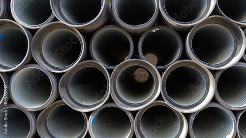 Black sewer pipes stacked  ready for undergrounding
