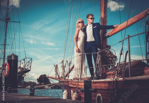 Fototapeta Stylish wealthy couple on a luxury yacht