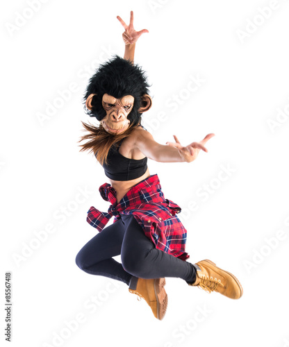 Woman with monkey mask jumping in hip hop style