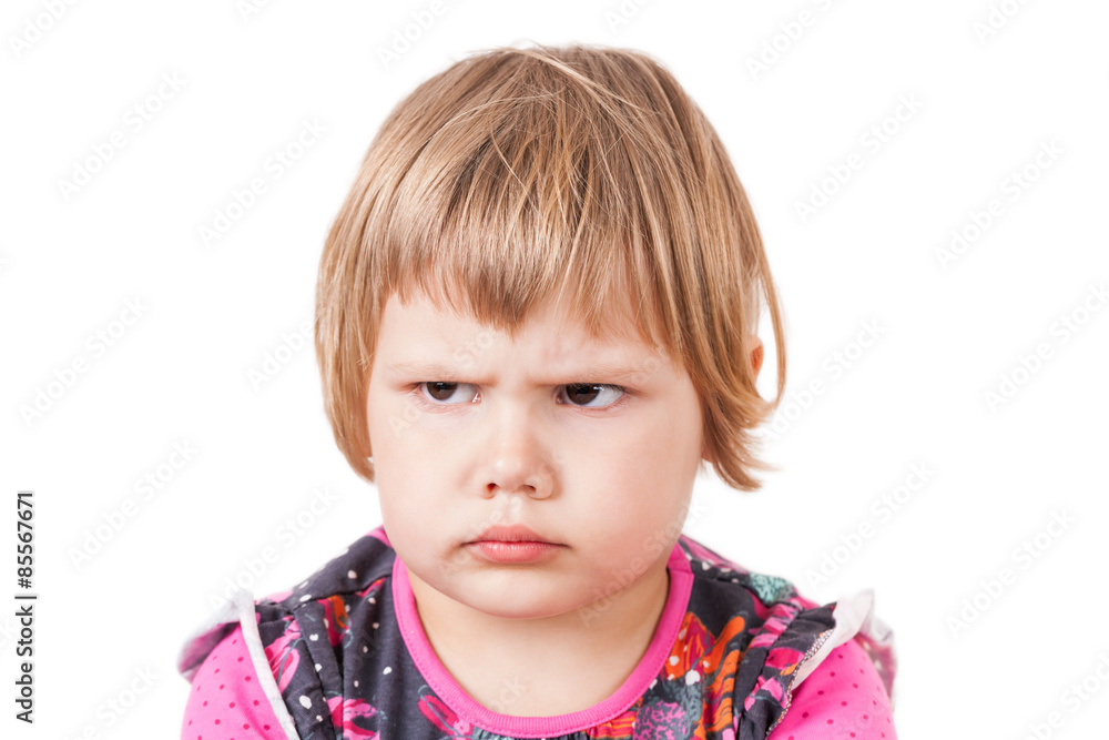Blond baby girl angry frowns, studio portrait Blond baby girl angry frowns, studio portrait
