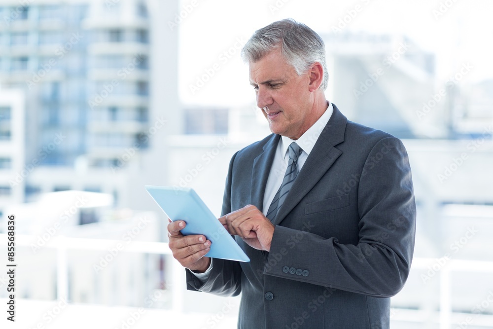 Businessman using his tablet Businessman using his tablet
