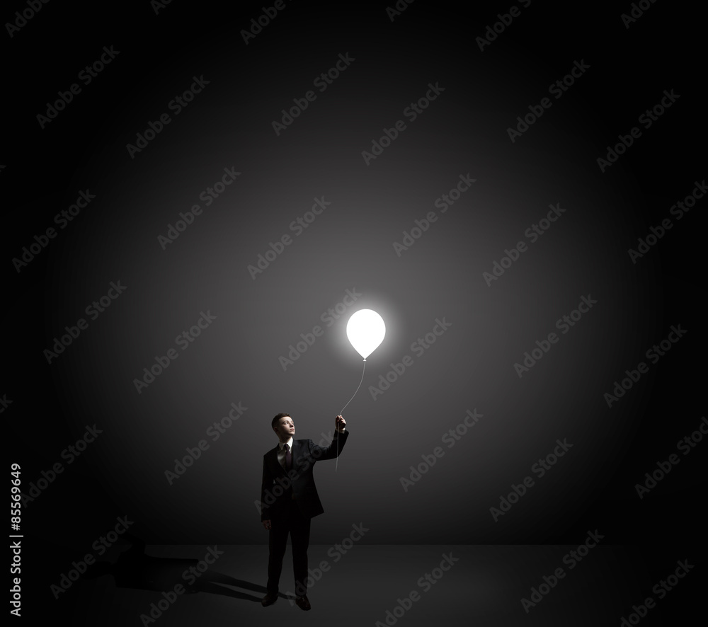 businessman holding flying light bulb businessman holding flying light bulb