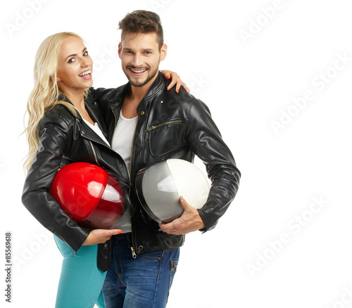 motorcyclists couple with helmets in hand