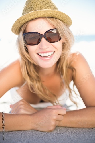 Pretty blonde relaxing beside the water looking at camera © WavebreakMediaMicro