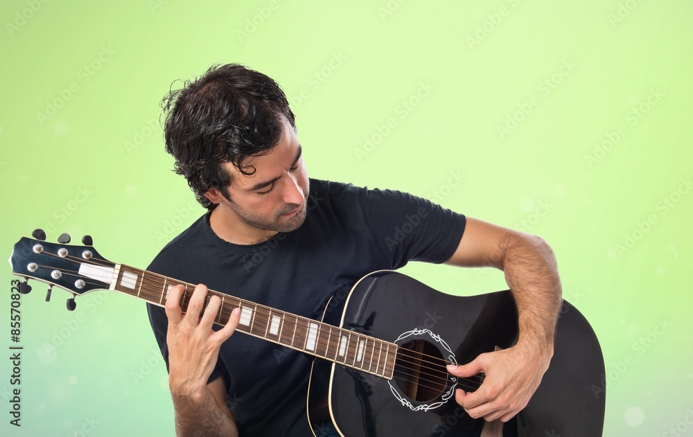 Obraz premium Handsome man with guitar over white background