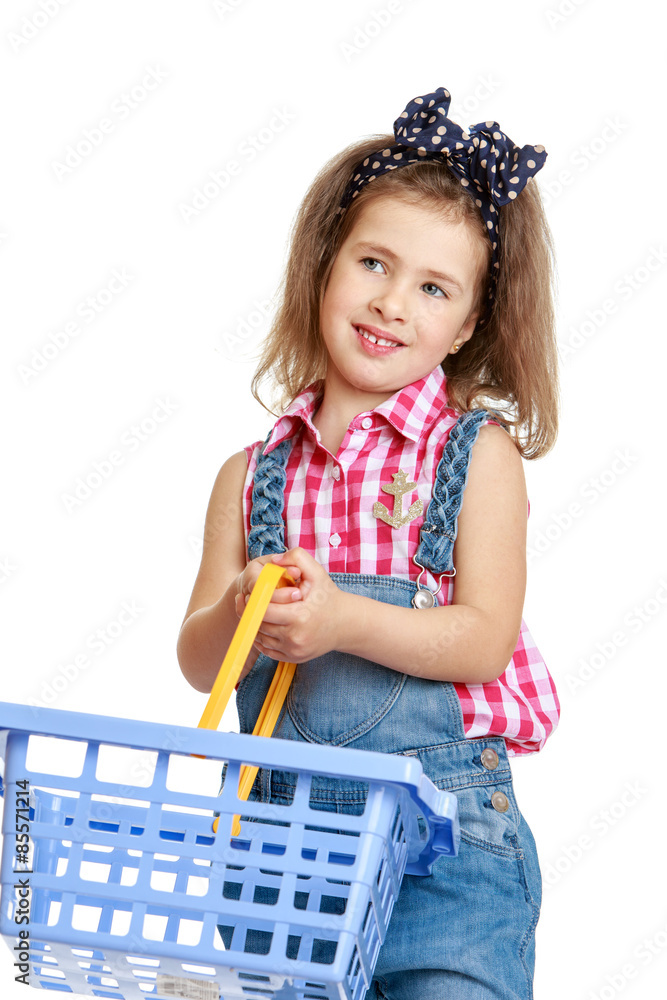 Beautiful, stylish little girl in denim overalls holding a Beautiful, stylish little girl in denim overalls holding a