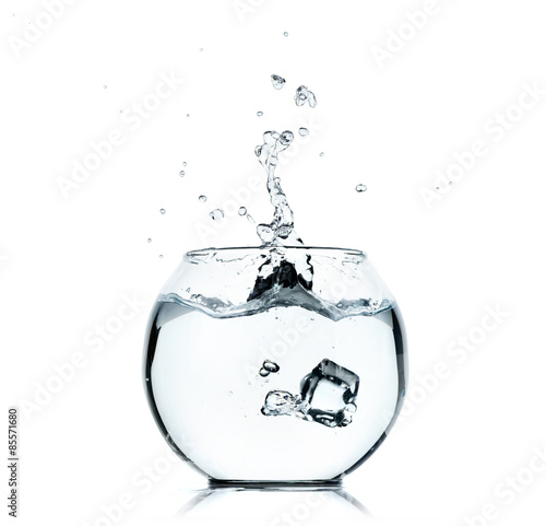 Water splashing from glass on white background