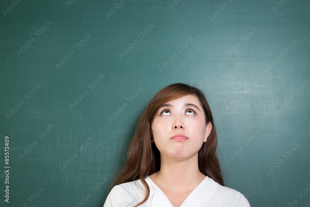 Asian beautiful woman standing in front of blackboard with gesture Asian beautiful woman standing in front of blackboard with gesture