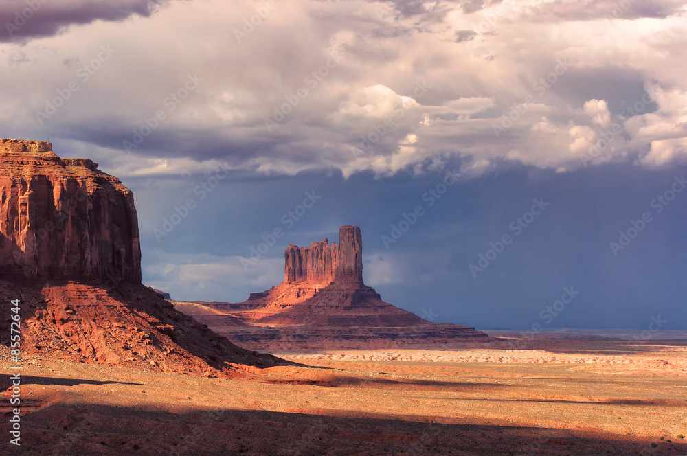 Stormy dramatic clouds over the Monument Valley at sunset, Arizona, USA