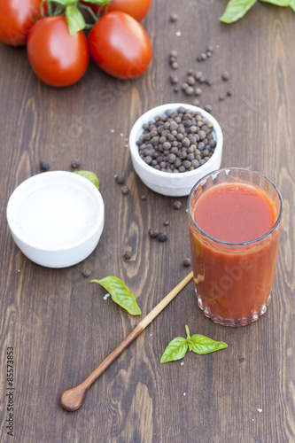 Fototapeta Naklejka Na Ścianę i Meble -  Tomato juice, tomatos, herbs and spices on wooden table