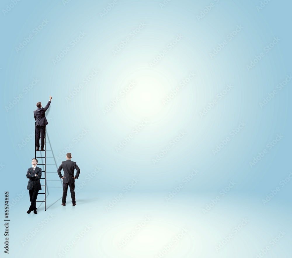 businessmen writing a concept on an empty wall businessmen writing a concept on an empty wall