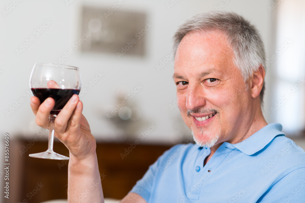 Mature man enjoying a glass of red wine Mature man enjoying a glass of red wine