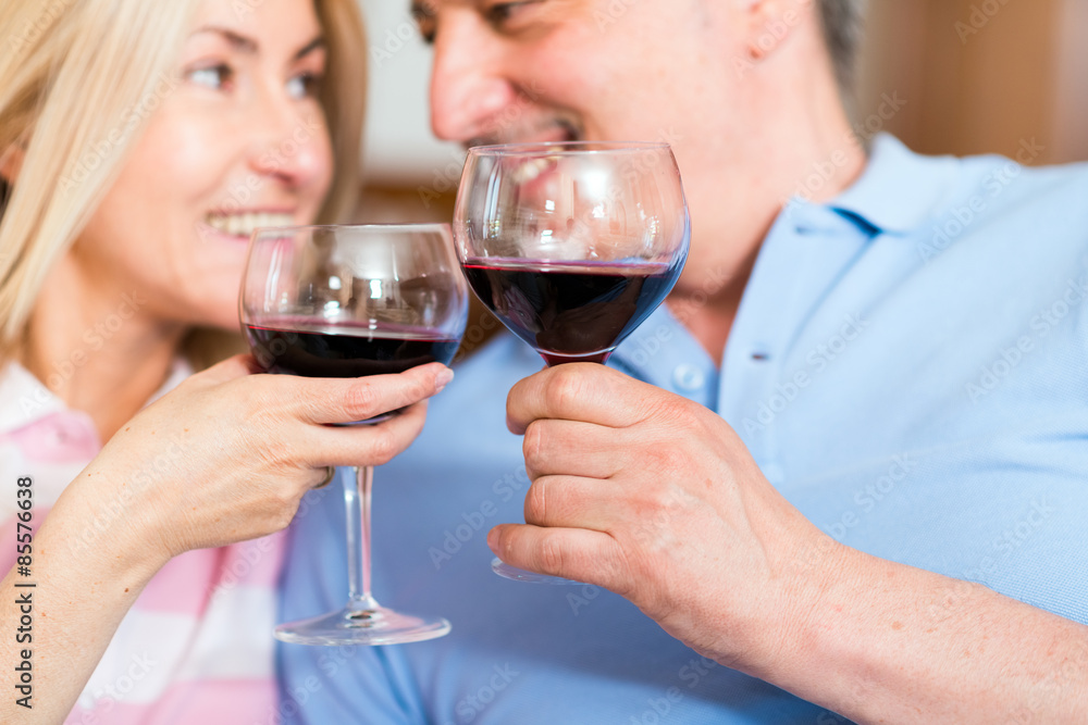Mature couple enjoying a glass of red wine