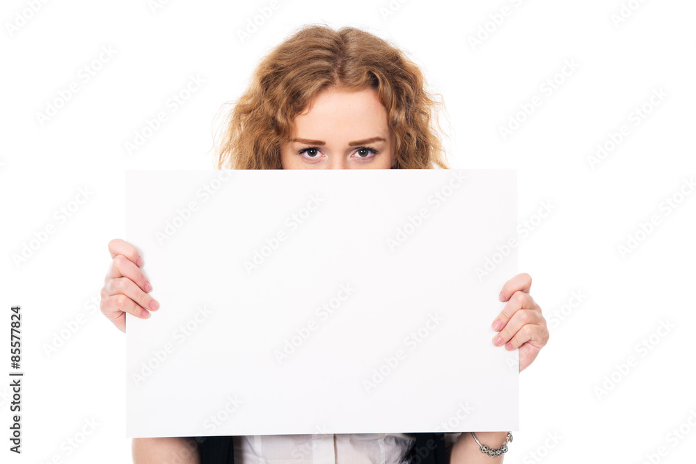 Young woman eyes over a blank promotional display isolated on a Young woman eyes over a blank promotional display isolated on a