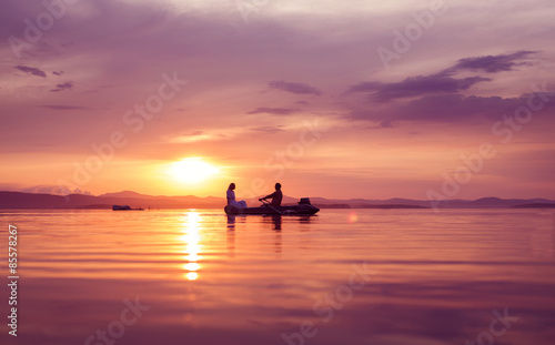 Man and woman in a boat at sunset