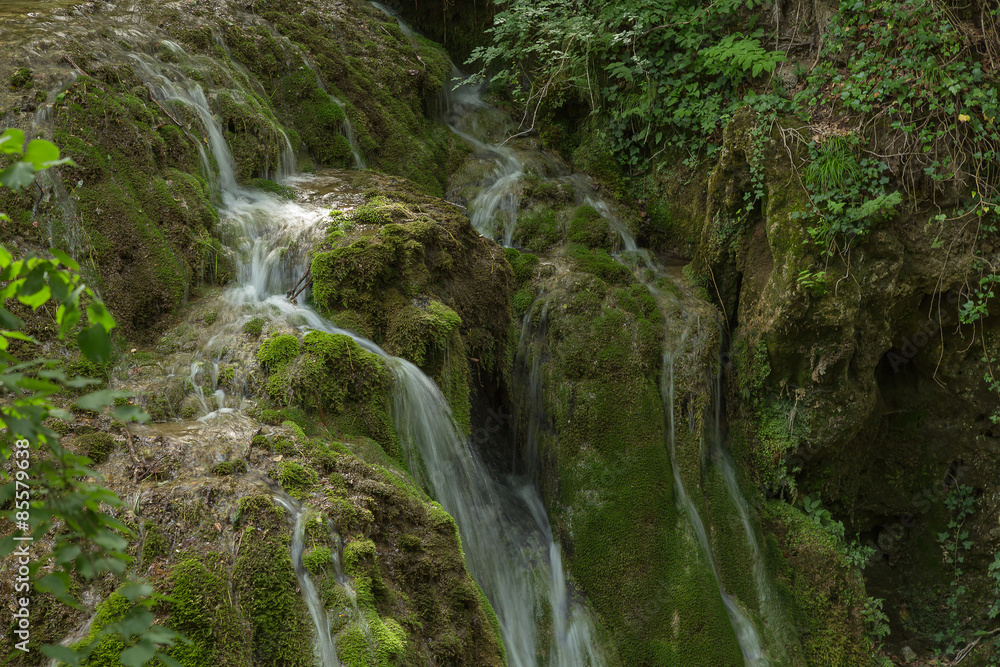Wild natural waterfall in a deep mountain forest