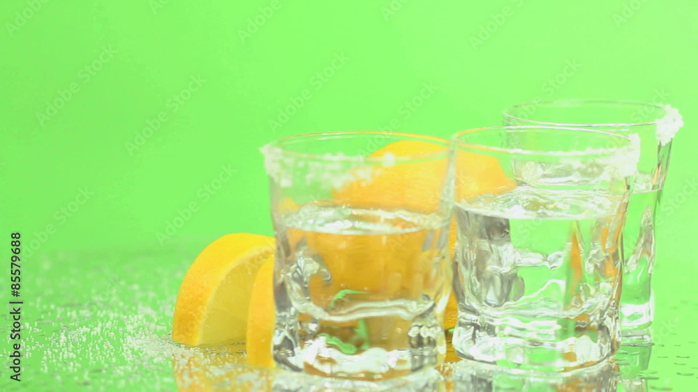 Green Screen Tequila shots - Tequila shots in frosty glasses with salt and lemon rotating on a green screen background, seamless loop. Green Screen Tequila shots - Tequila shots in frosty glasses with salt and lemon rotating on a green screen background, seamless loop.
