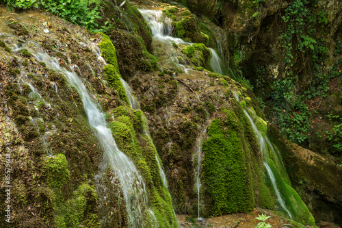 Wild natural waterfall in a deep mountain forest