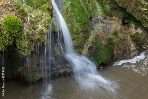 Wild natural waterfall in a deep mountain forest