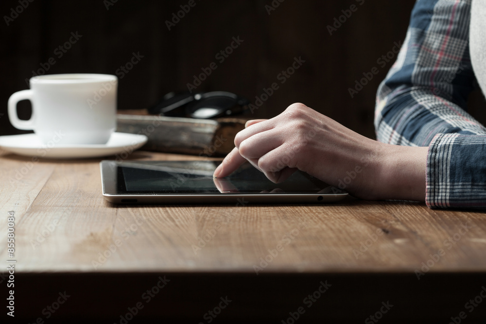 woman hand presses on screen digital tablet