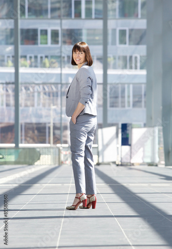 Business woman standing inside city building