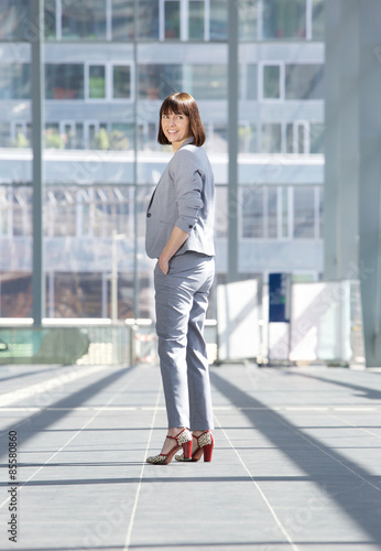 Business woman standing inside city building © mimagephotos