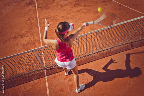 Young woman playing tennis.High angle view.Forehand volley. © BalanceFormCreative