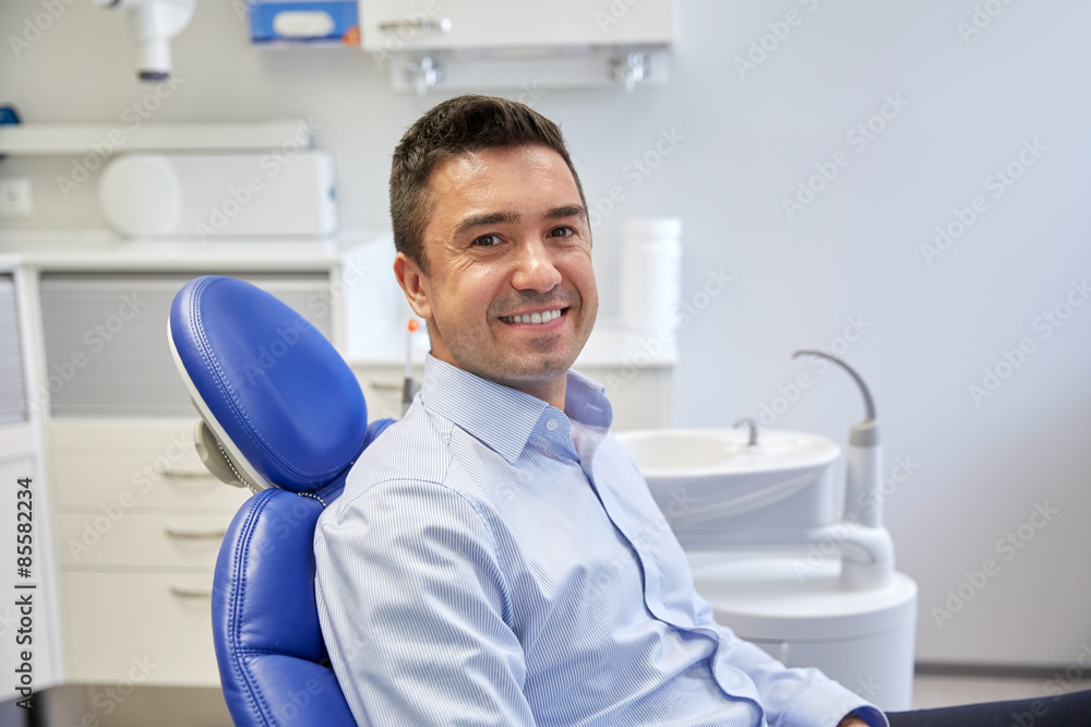 happy male patient sitting on dental chair happy male patient sitting on dental chair