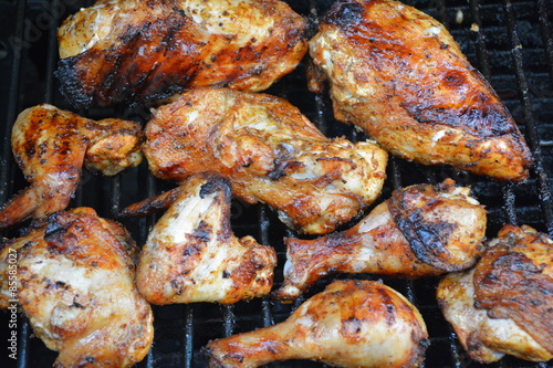 Golden brown chicken cooking on barbecue