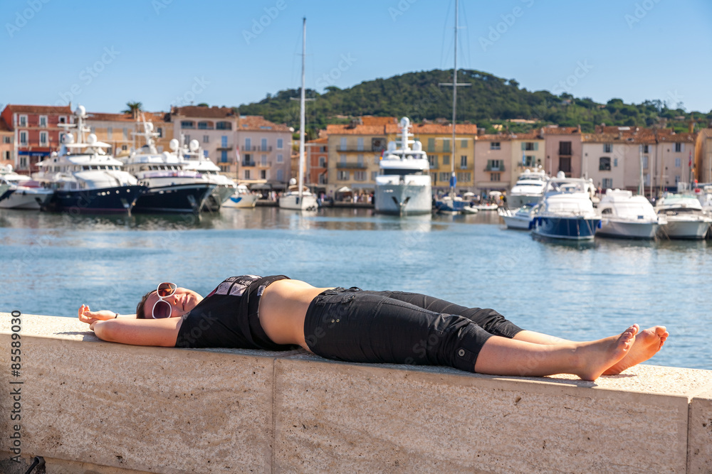 Girl and yachts on the coast of Saint Tropez, France 