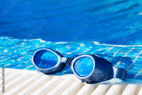 Swimming pool goggles on the poolside