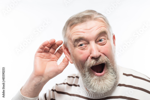 an old man with a beard is hard of hearing, health problems
