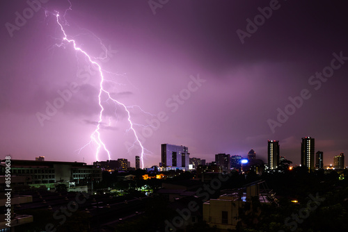 Strike of lightning into building in city.