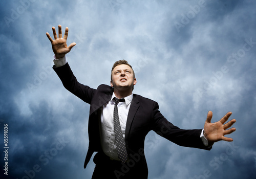 Crazy young man throws himself in front of him to attack. I want to catch something. He is furious and determined to reach your goal.